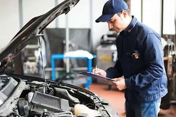 A service staff doing a vehicle checklist