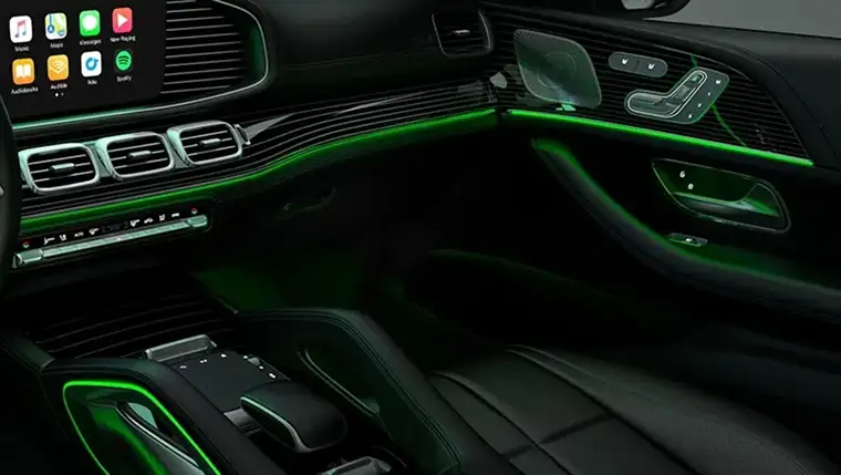 GLS cabin at night lit green by the ambient lighting along the dash and console