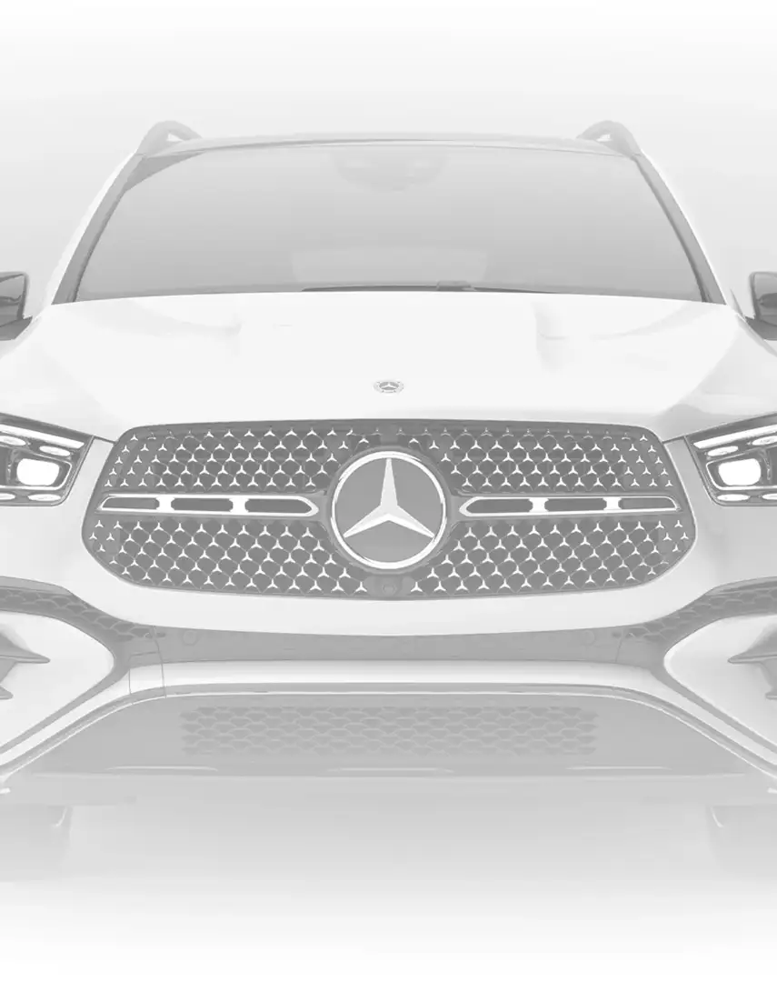 White C 300 4MATIC Sedan seen head-on with its Star-pattern grille against a pale backdrop.