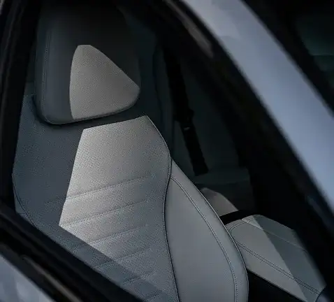 Front seat of the C-Class in light grey upholstery seen through the open door.