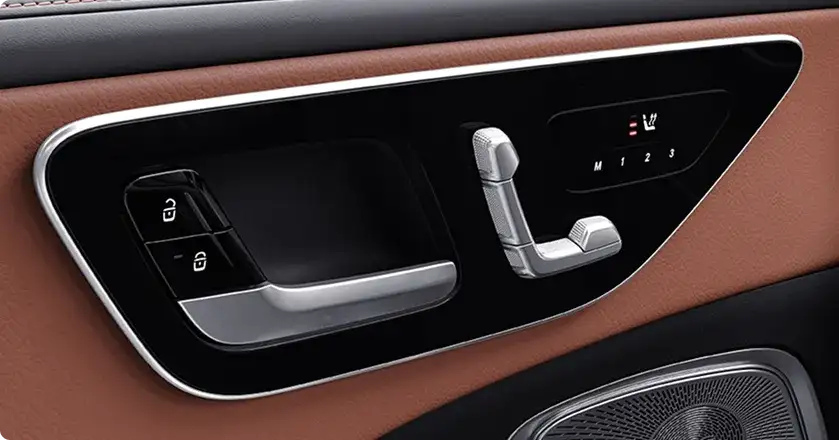 Seat controls on the C-Class door panel beside saddle brown upholstery.