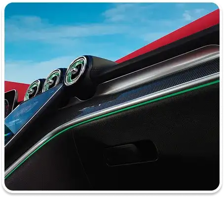 C-Class cockpit lit in green ambient light with a red wall visible through the windscreen.