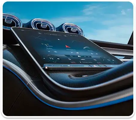 C-Class dashboard and passenger-side trim lit in blue ambient light.