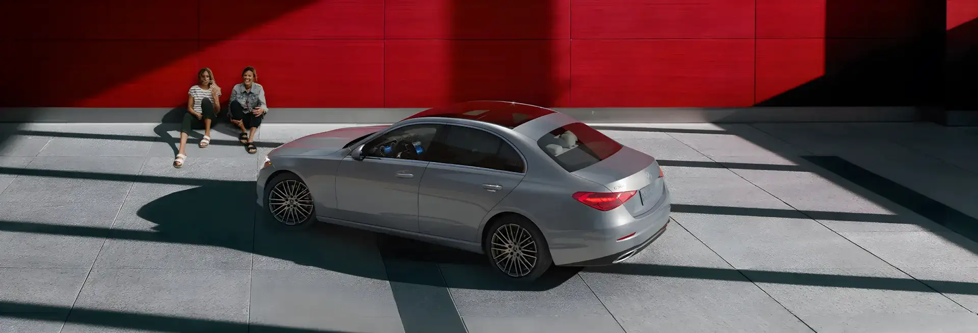 Silver C 300 4MATIC Sedan photographed head-on against a pale studio backdrop.