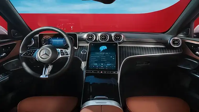 C-Class cockpit with the portrait touchscreen and saddle brown trim, seen from the passenger side.
