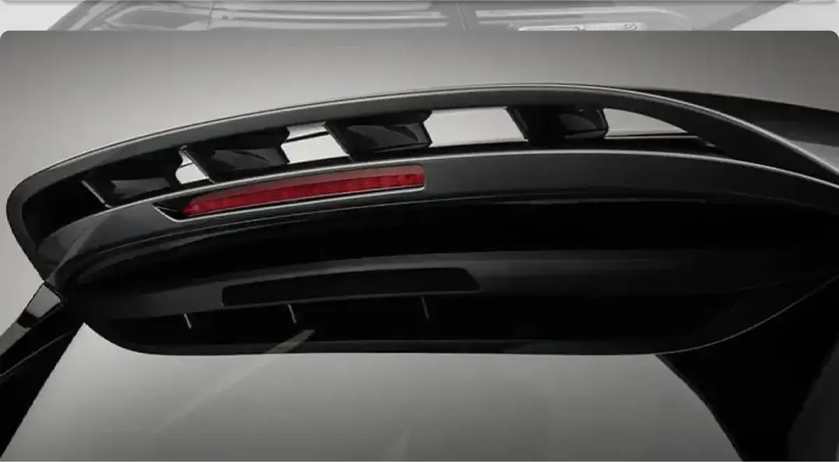 Black body-color roof spoiler with an integrated brake light above the tailgate glass.
