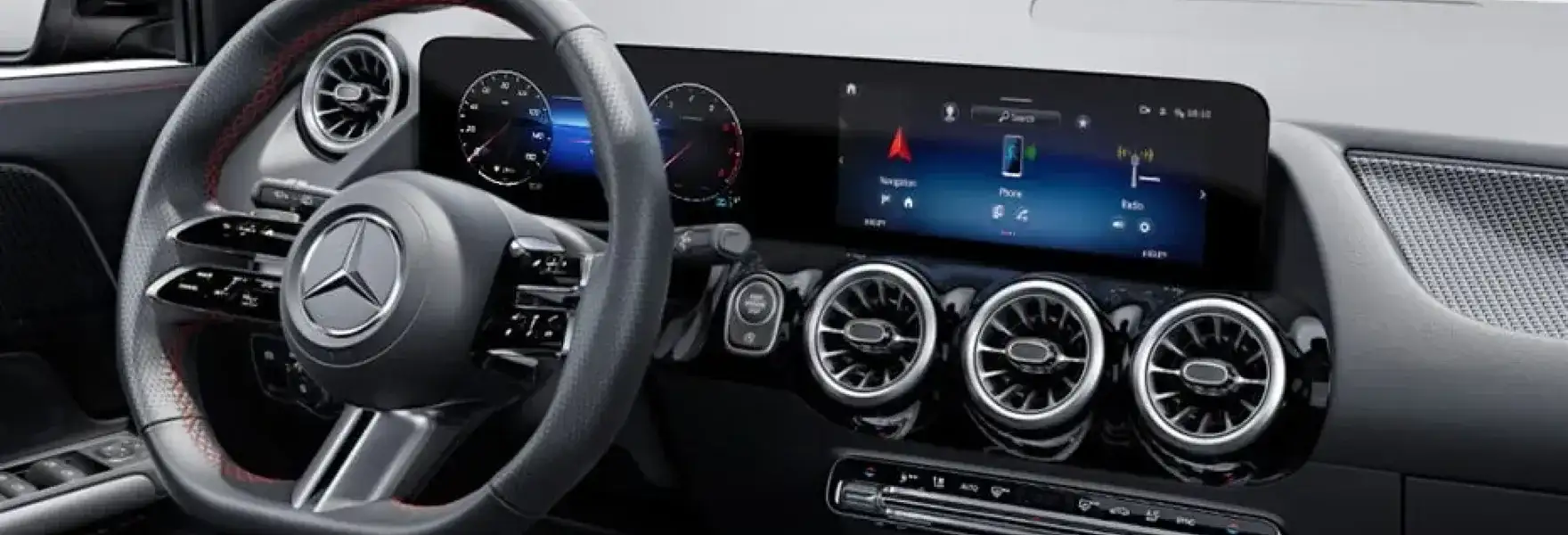 GLA cockpit showing the twin widescreen displays.