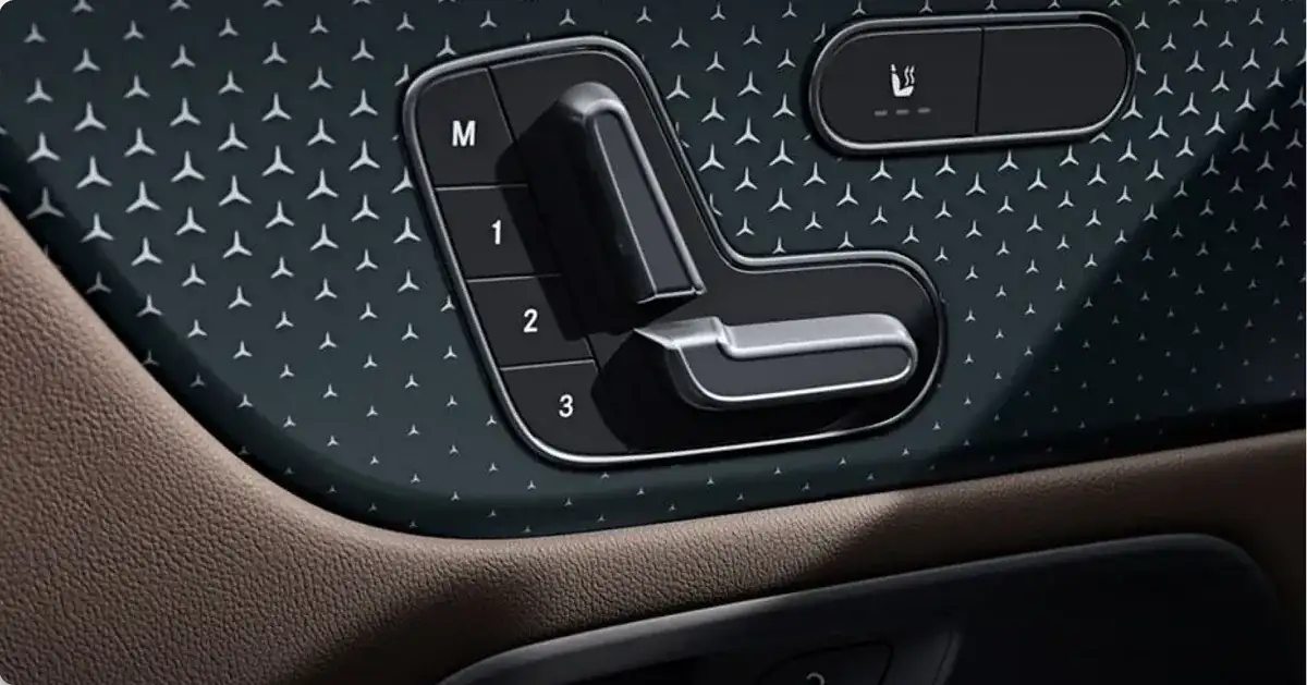 Seat-shaped power seat controls and memory buttons on the GLA door panel.