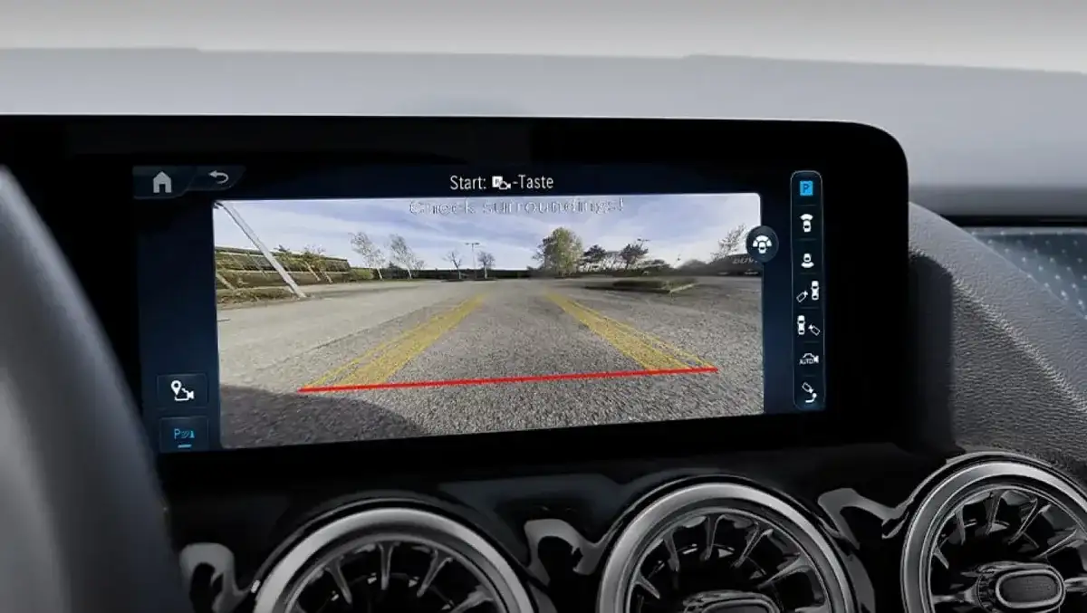 Central display showing the rearview camera view with active parking guidelines.