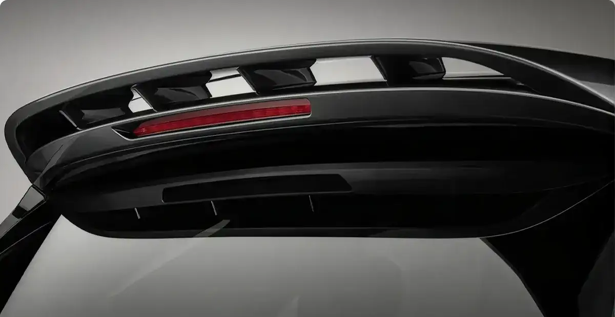 Black body-color roof spoiler with an integrated brake light above the tailgate glass.