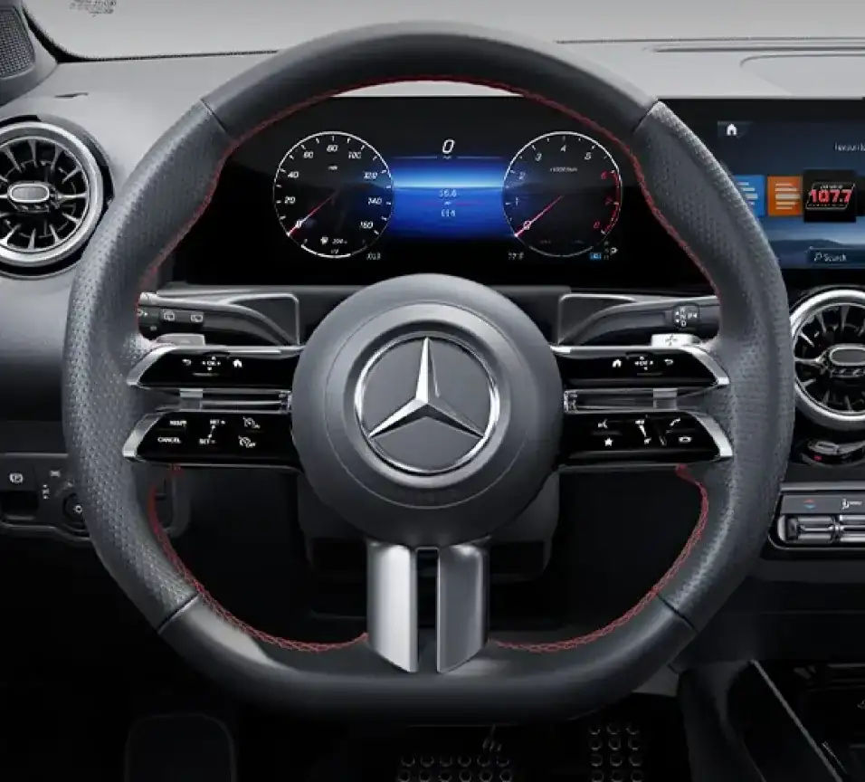 GLB multifunction steering wheel with red contrast stitching in front of the digital gauges.