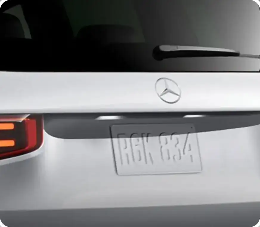 Rear liftgate of a white GLB with chrome trim above the licence plate.