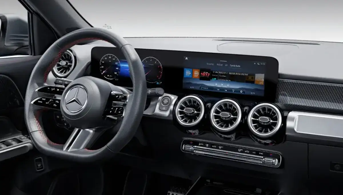 Central touchscreen showing the MBUX home screen tiles.