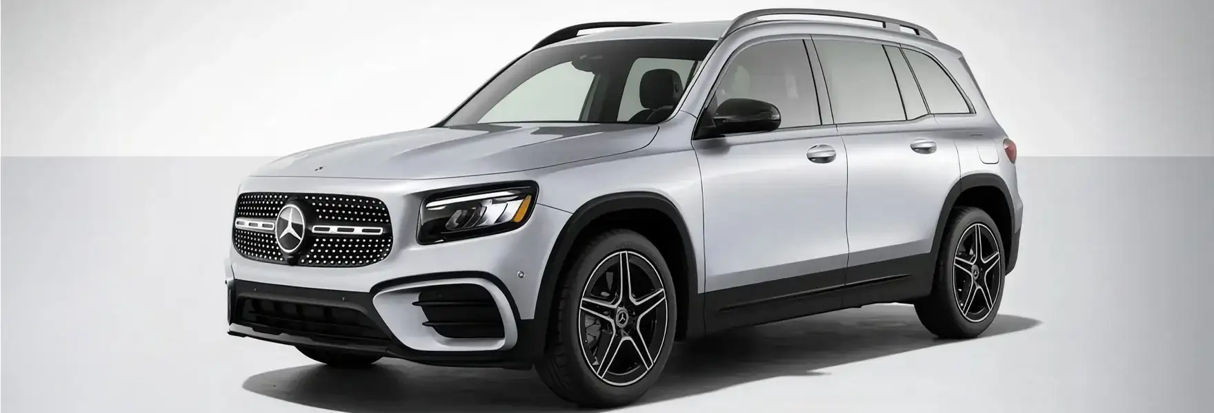 White GLB 250 4MATIC SUV shown from a rear three-quarter angle on a pale grey backdrop.
