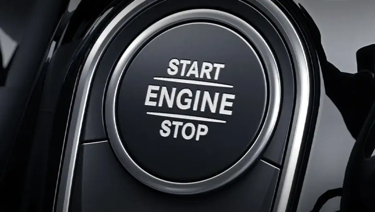 Mercedes-Benz SmartKey held beside the GLB Start/Stop button on the dash.