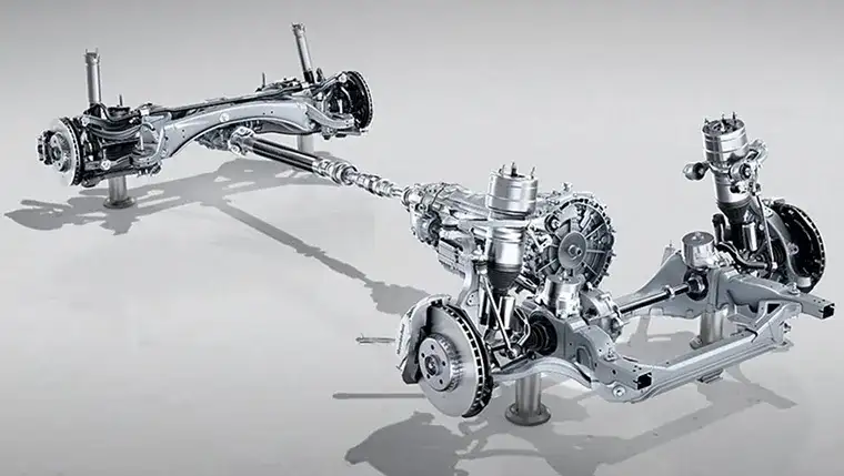 E-Class cornering on a wet road with 4MATIC all-wheel drive distributing torque to every wheel.