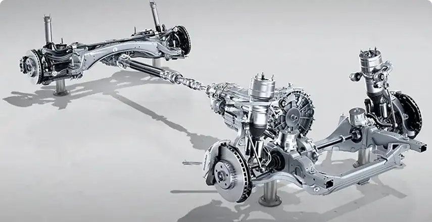 Mercedes-Benz E-Class driving on a wet road, demonstrating 4MATIC all-wheel drive traction.