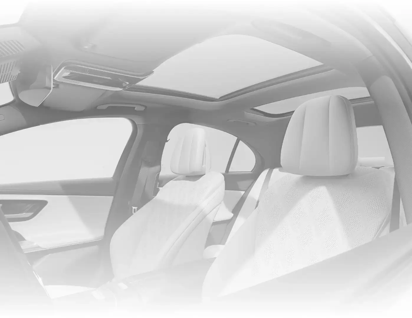 E-Class cabin in light grey diamond-quilted upholstery, seen through the open door beneath the panorama roof.