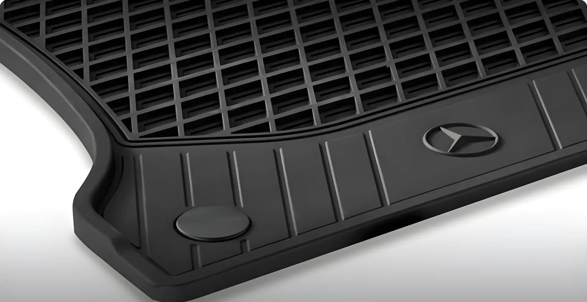 Set of black rubber all-season floor mats with deep water-trapping channels.
