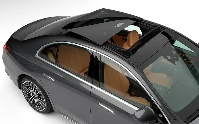 Overhead view of the E-Class panorama roof with the saddle brown cabin visible through the glass.