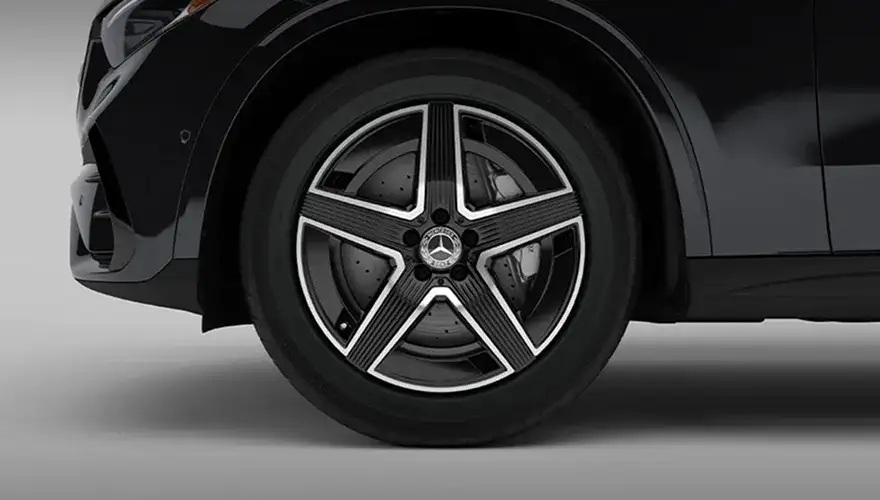 19-inch AMG five-spoke wheel finished in black with polished silver edges.