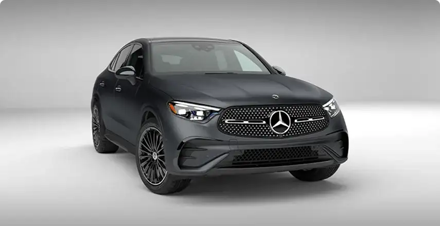 Black GLC 300 4MATIC Coupe with AMG body styling, shown from the front on a grey backdrop.