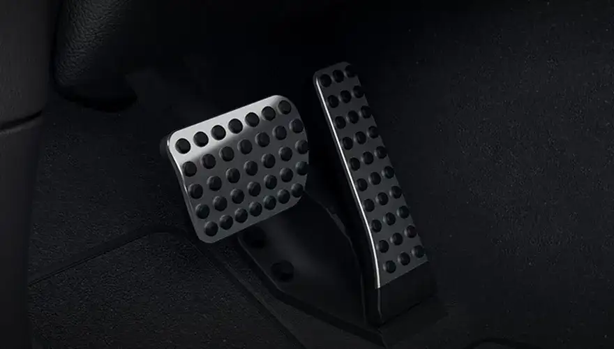 Brushed stainless steel pedals with rubber studs in the GLC footwell.