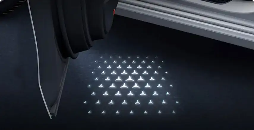 Star pattern projected onto the ground beside the open door of the GLC Coupe.