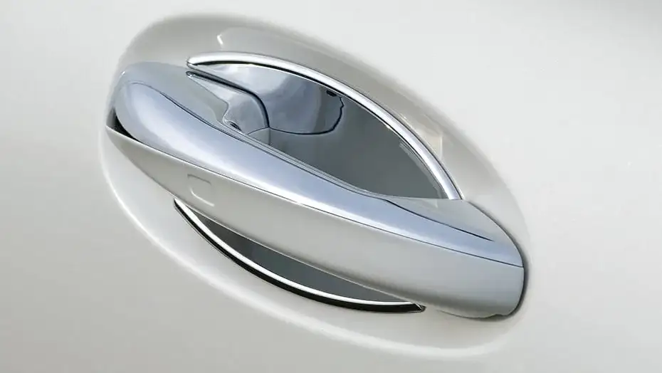 Chrome insert fitted to the door handle recess of a silver GLC.