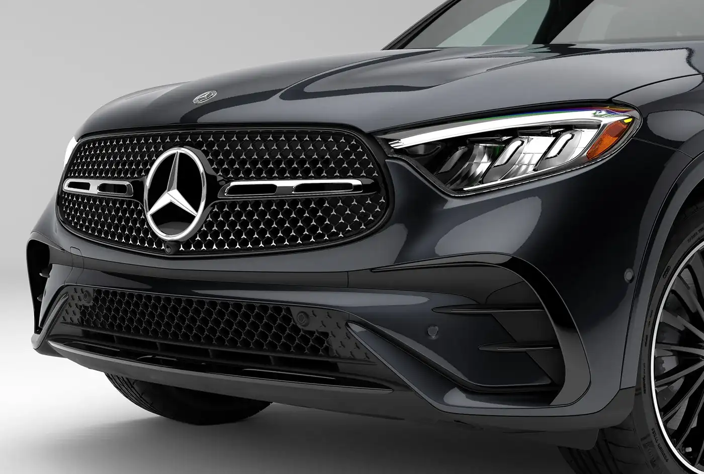 Close view of the Star-pattern grille and LED headlamp on a black GLC 300.