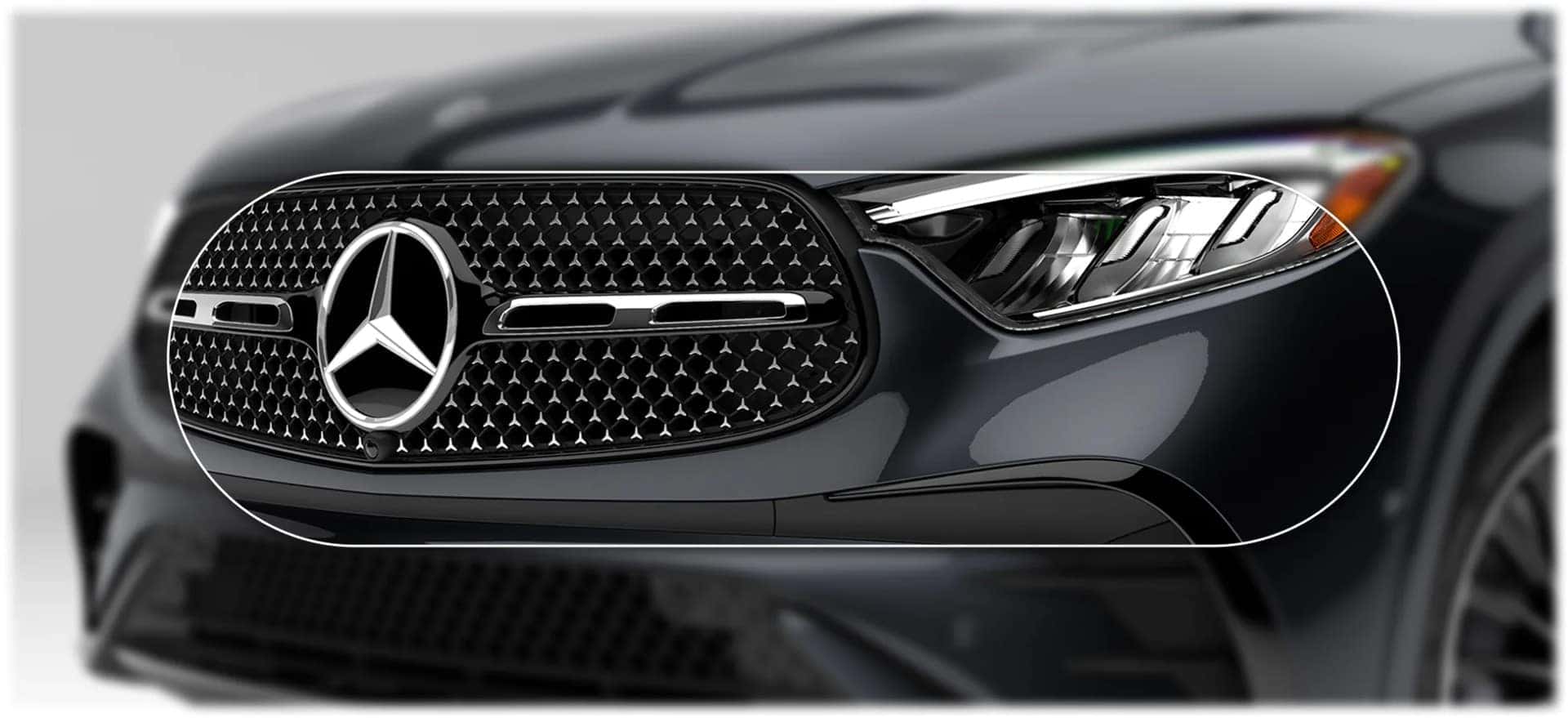 Close crop of the Star-pattern grille and LED headlamp on a graphite 2027 GLC 300 4MATIC&reg; SUV.