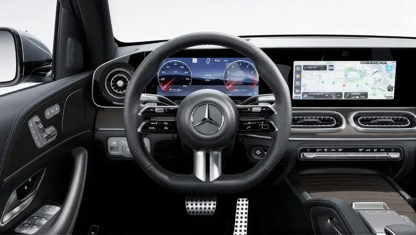 Flat-bottom sport steering wheel in front of the digital instrument cluster and touchscreen.