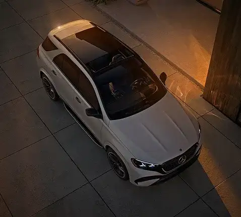 Overhead view of a white GLE 450 4MATIC SUV parked on a stone patio.