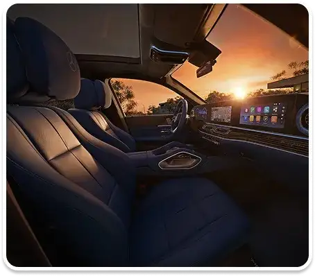 GLE front seats in dark blue leather with the dashboard displays glowing at sunset.