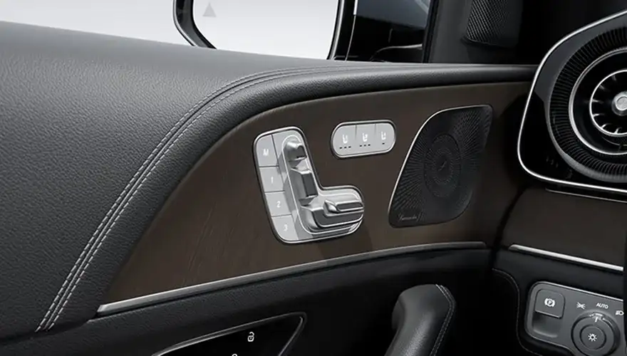 Seat-shaped power seat controls and memory buttons on the GLE door panel.