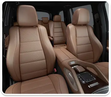 Brown leather front seats and center console seen from the passenger side