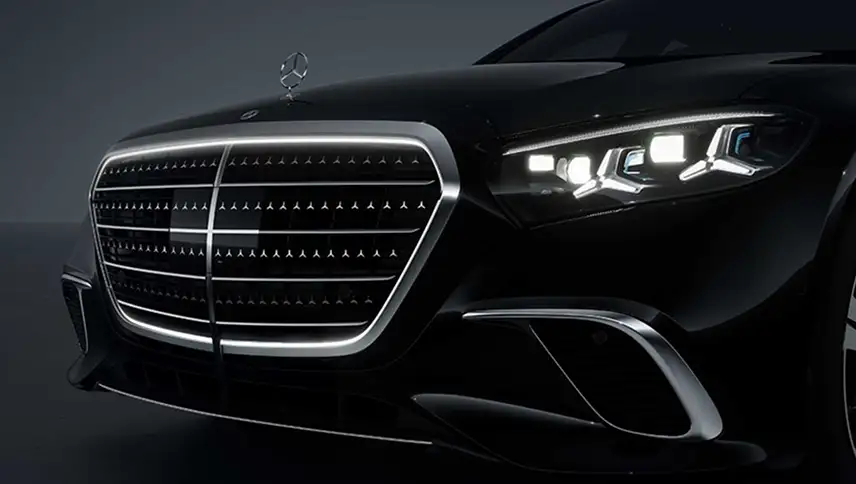 Illuminated chrome radiator grille and LED headlamps on a black S-Class