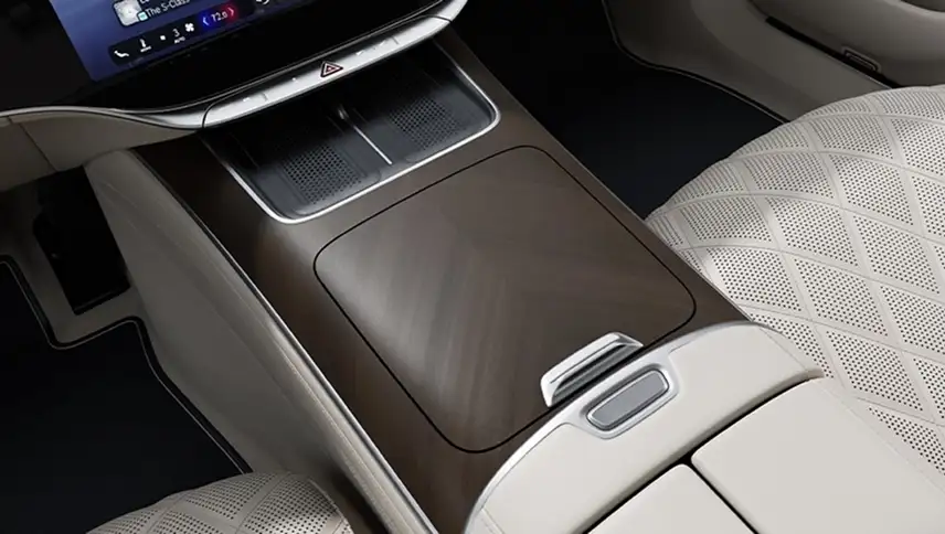 Brown herringbone wood console trim beside cream diamond-quilted seats