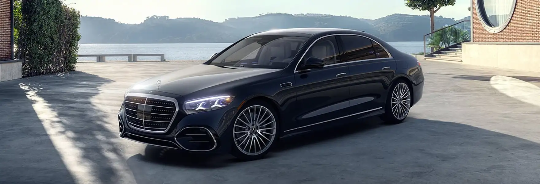Dark blue Mercedes-Benz S-Class parked on a waterfront terrace