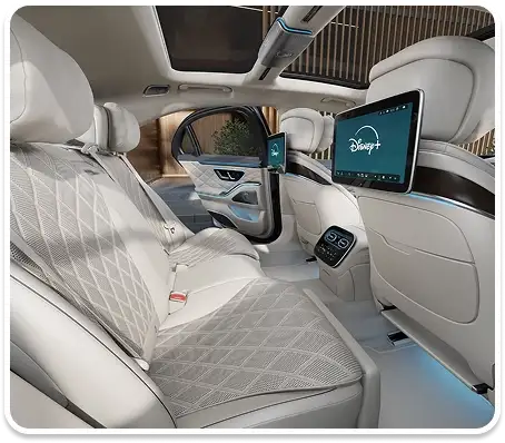 Rear cabin with cream quilted seats and a rear entertainment screen