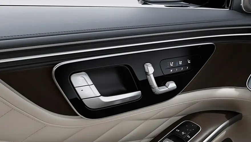 Cream and brown door panel with the seat adjustment controls