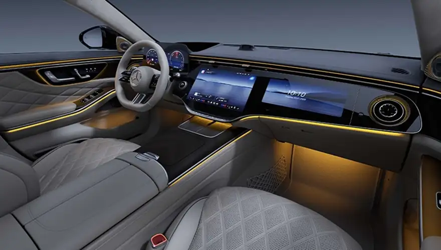Cabin at night lit by amber ambient lighting running along the dashboard