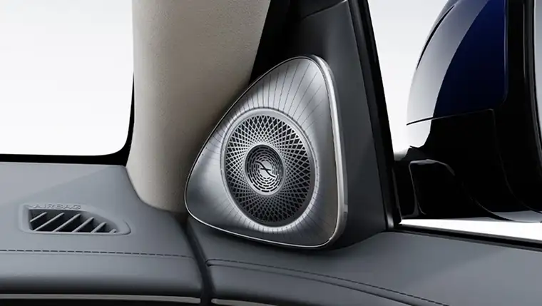 Metal Burmester speaker grille set into a cream cabin pillar