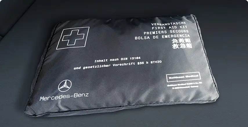 Black Mercedes-Benz first-aid pouch marked with a white cross