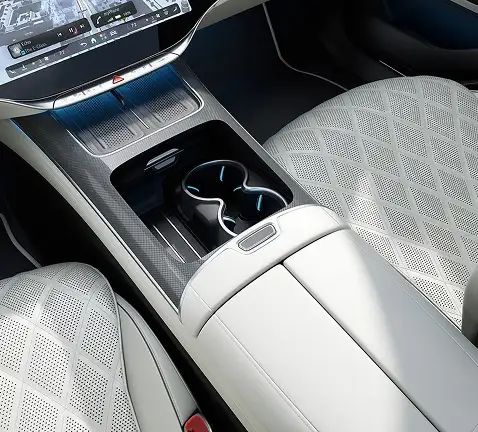 Front center console with cupholders between cream quilted seats