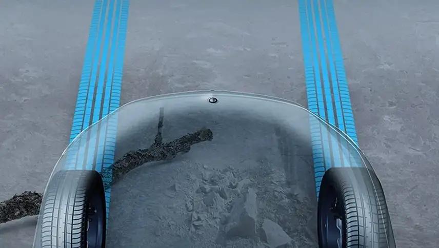 Transparent Hood display showing the rocky ground beneath the front wheels