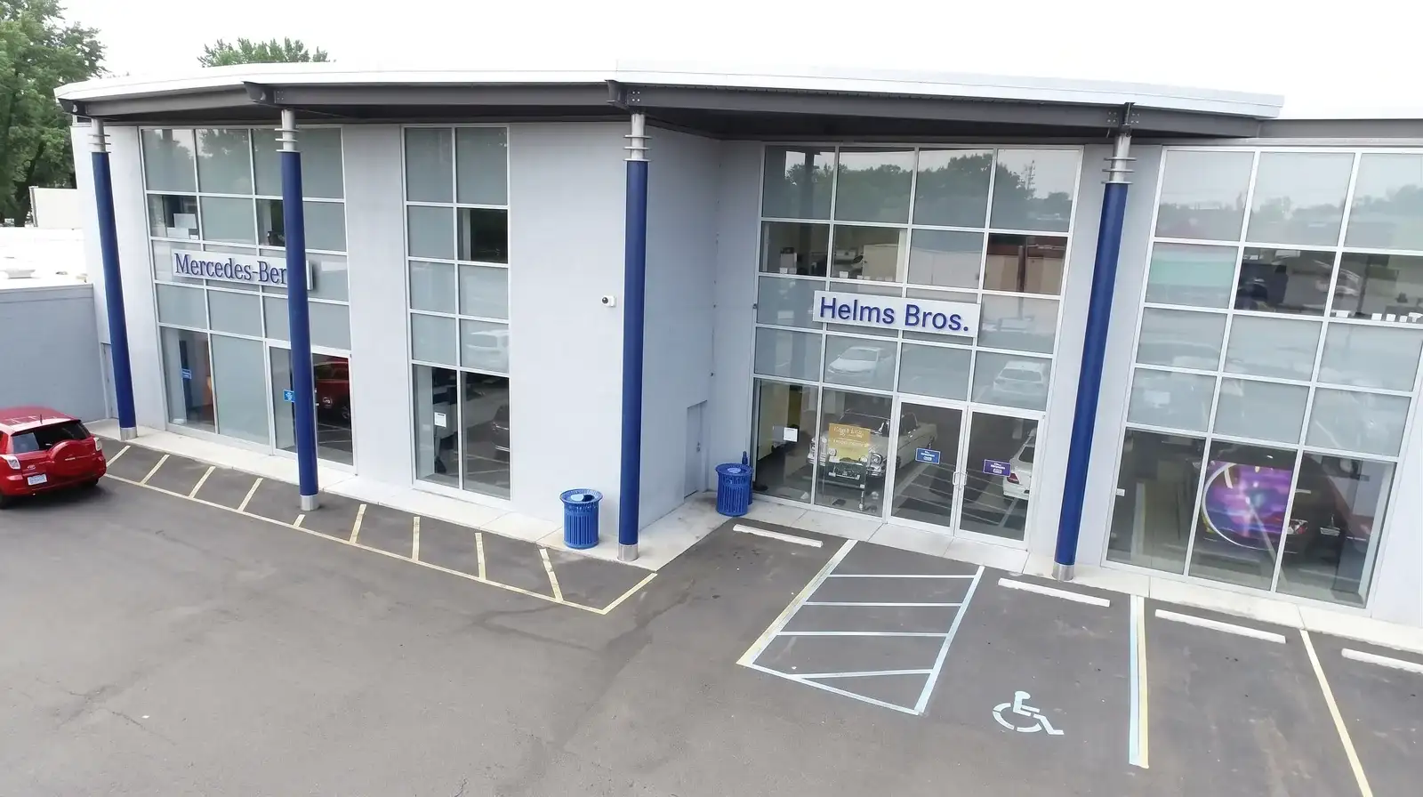 The Helms Bros. Mercedes-Benz dealership from above, the showroom glass and the blue columns along the front