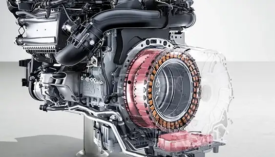 Cutaway engine on a stand showing the copper starter-generator windings