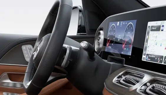 Steering wheel shift paddle in front of the digital instrument cluster and touchscreen