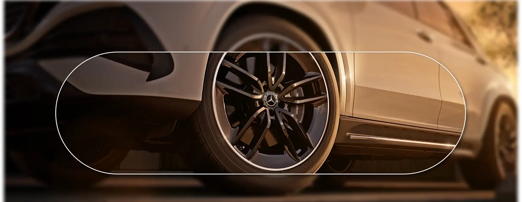 Black multi-spoke alloy wheel on a white GLE framed by a thin capsule outline